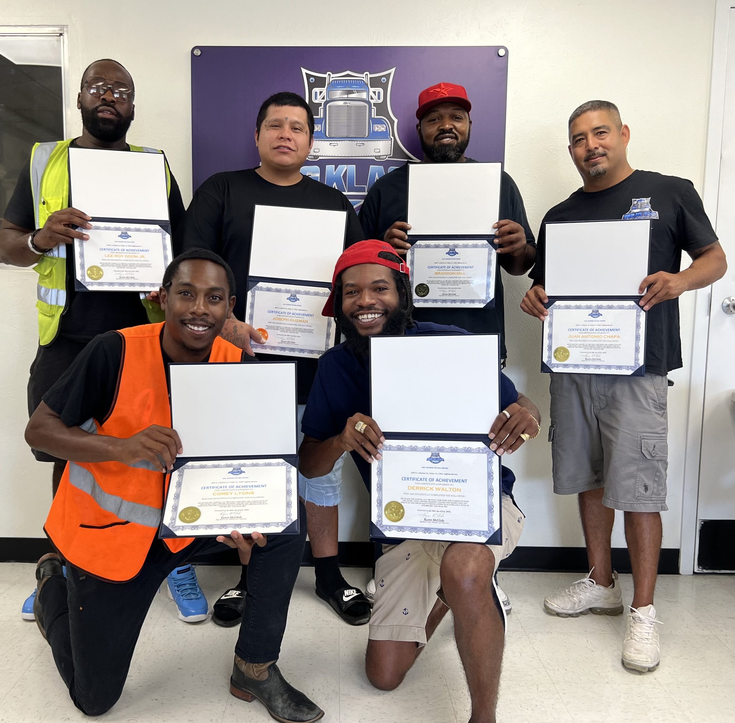 Successful Big Klass CDL School graduates displaying their certificates